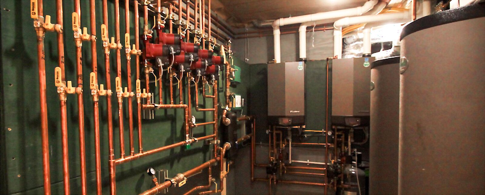 Copper near-boiler piping with zone valves and twin condensing boilers in a mechanical room